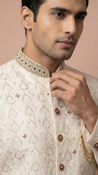Cream Embroidered Sherwani with Stone Accents and Chain Brooch